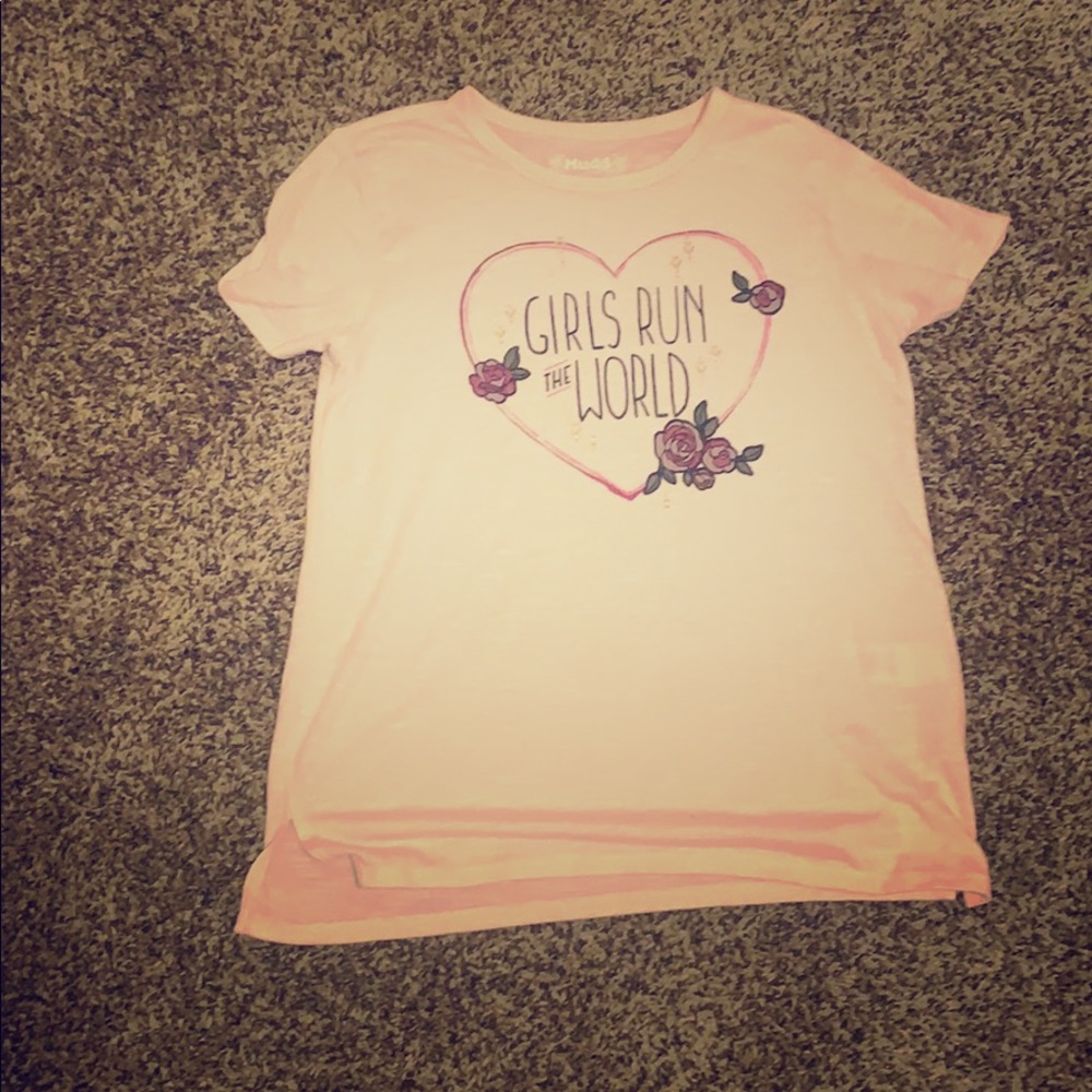 A pink shirt with the print,“Girls run the World”